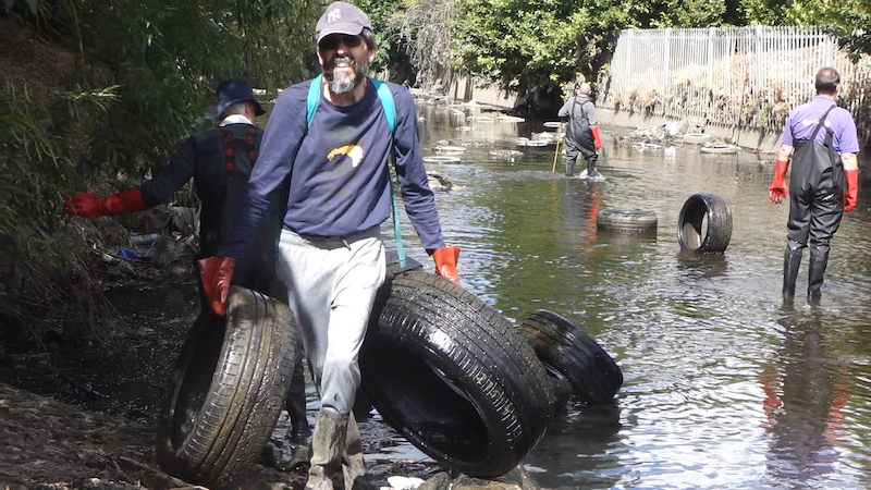 Volunteers clear dumped tyres from the river